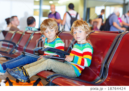 Two tired little sibling boys at the airport Two tired little sibling boys at the airport 18764424