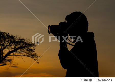 silhouette of photographer taking picture. 18766223