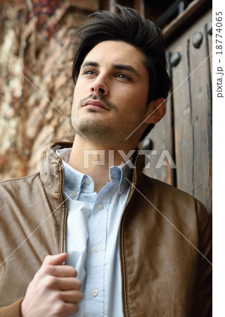 Attractive young handsome man, model of fashion in urban backgro 18774065