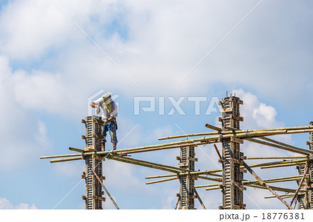 Worker working in construction on blue sky Worker working in construction on blue sky 18776381