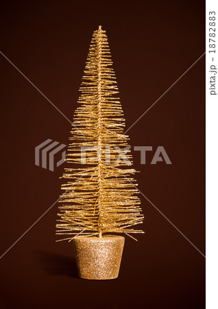 golden toy christmas tree on dark brown 18782883