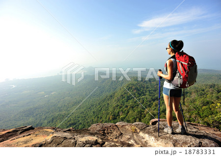 woman hiker enjoy the view at sunset mountain peak 18783331