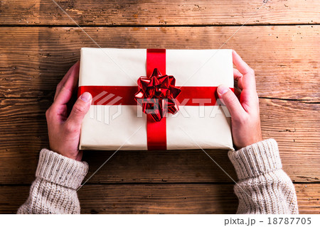 Man holding Christmas present 18787705