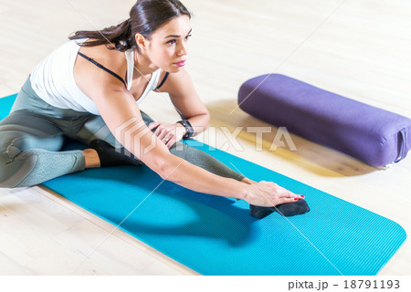 Fit woman doing stretching pilates exercises in Fit woman doing stretching pilates exercises in 18791193