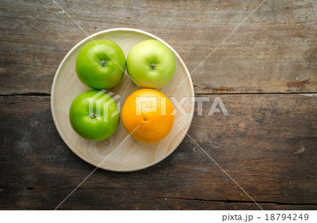 Top view of green apples and orange on wood panel 18794249