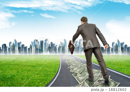 Man with suitcase on money road 18812602