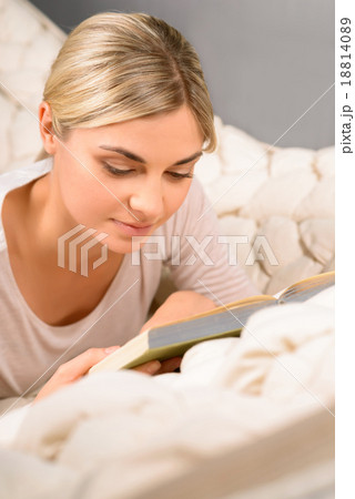Young woman reading while being in the hammock.  18814089