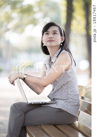 Portrait of a smiling young business woman using laptop 18817467