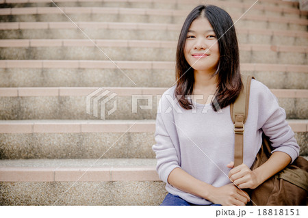 attractive female college student sitting on stairs attractive female college student sitting on stairs 18818151
