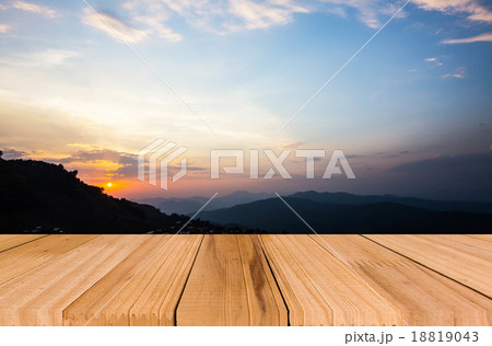 Close up top of old wooden table with blur sunset background 18819043