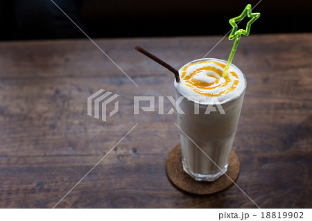 Vanilla milk shake on wooden table Vanilla milk shake on wooden table 18819902