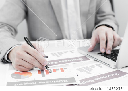 Businessman analyzing investment charts with laptop. Accounting 18820574