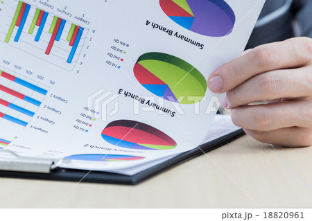 Businessman's hand showing financial report Businessman's hand showing financial report 18820961