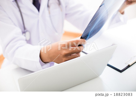 close up of male doctor holding x-ray or roentgen image close up of male doctor holding x-ray or roentgen image 18823083