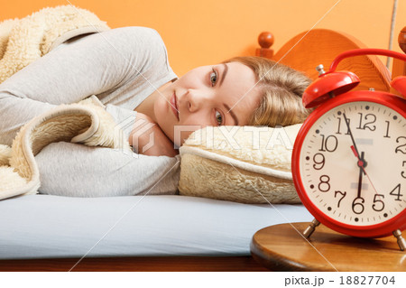 Woman rest in bed under blanket with alarm clock. Woman rest in bed under blanket with alarm clock. 18827704