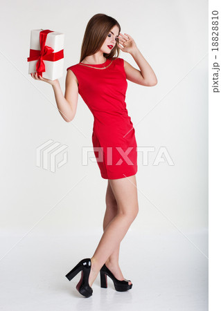 Pretty girl in red dress with gift box  Pretty girl in red dress with gift box  18828810