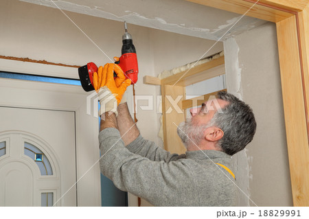 Construction site, worker installing gypsum board 18829991