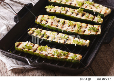 zucchini with cheese on a grill pan close-up 18830547