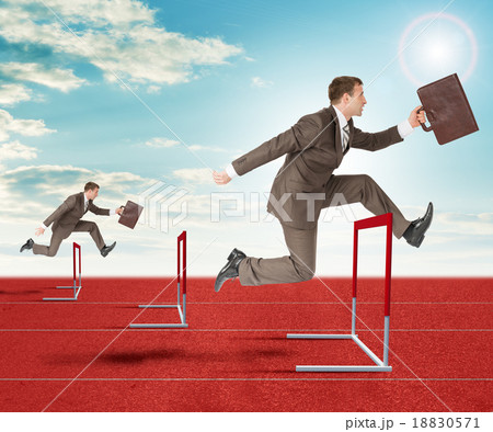 Businessmen hopping over treadmill barrier Businessmen hopping over treadmill barrier 18830571