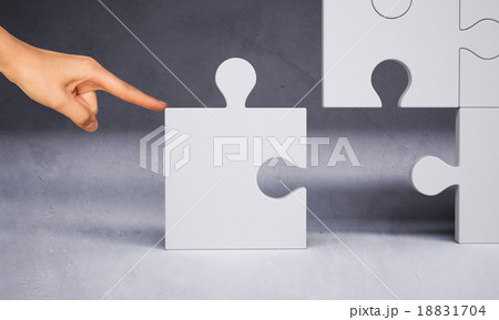 Man hand pushing puzzle piece 18831704