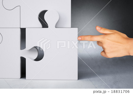 Businessman hand touching puzzle piece Businessman hand touching puzzle piece 18831706