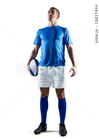 Full length of confident rugby player holding ball 18835844