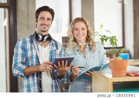Portrait of happy business people holding digital tablet in crea Portrait of happy business people holding digital tablet in crea 18835991