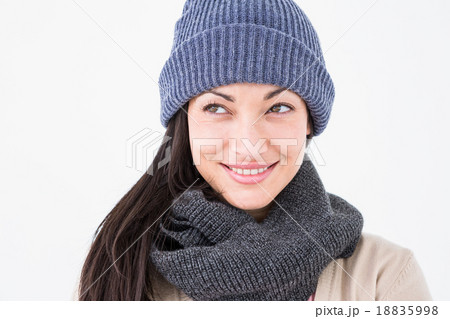 Attractive brunette looking up wearing warm clothes 18835998