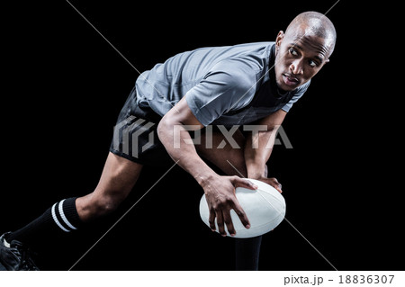 Determined sportsman looking away while playing rugby Determined sportsman looking away while playing rugby 18836307