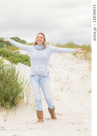 Smiling woman standing with open arms 18836615