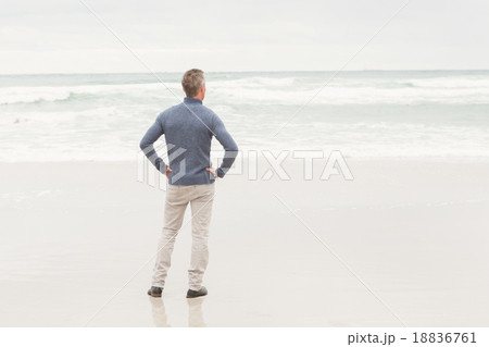 Man standing at the edge of the sea Man standing at the edge of the sea 18836761