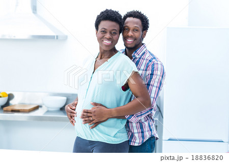 Portrait of man embracing his wife while standing Portrait of man embracing his wife while standing 18836820