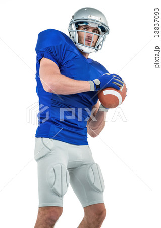 Confident American football player throwing the ball Confident American football player throwing the ball 18837093