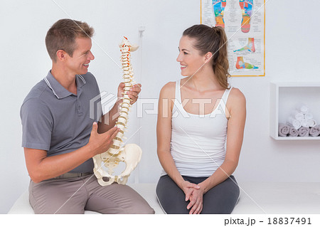 Doctor showing anatomical spine to his patient Doctor showing anatomical spine to his patient 18837491