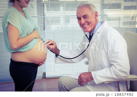 Portrait of doctor examining pregnant woman 18837492