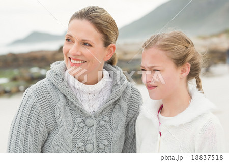Mother and daughter looing towards the sea 18837518