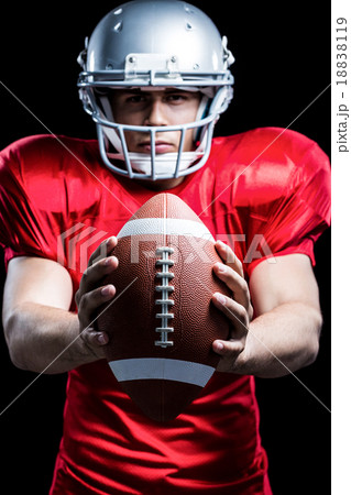 Portrait of American football player holding ball 18838119