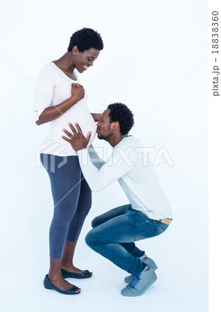 Affectionate man kissing belly of his wife Affectionate man kissing belly of his wife 18838360