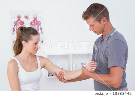 Doctor examining his patient arm 18838449
