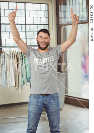 Man with arms raised standing in office 18838450