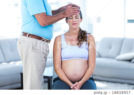 Therapist massaging pregnant woman Therapist massaging pregnant woman 18838957