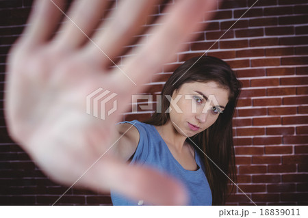 Pretty brunette with hand up Pretty brunette with hand up 18839011