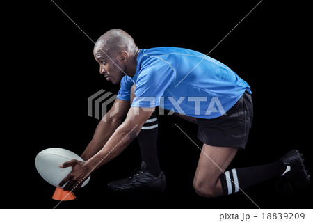 Rugby player keeping ball on kicking tee 18839209