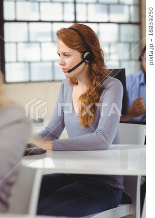 Concentrated female operator in office Concentrated female operator in office 18839250