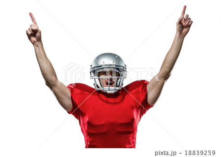 American football player with arms raised standing 18839259