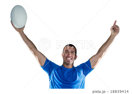 Portrait of rugby player in blue jersey holding ball with arms r Portrait of rugby player in blue jersey holding ball with arms r 18839414
