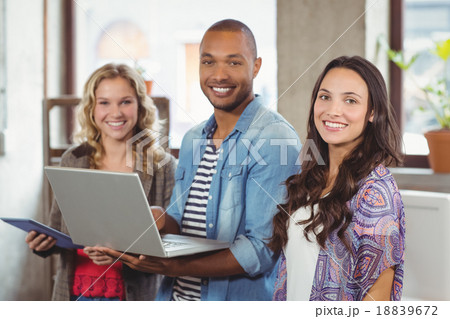Happy business people using technologies in office Happy business people using technologies in office 18839672