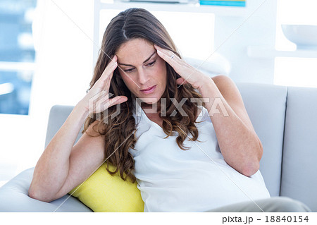 Depressed pregnant woman sitting on sofa Depressed pregnant woman sitting on sofa 18840154