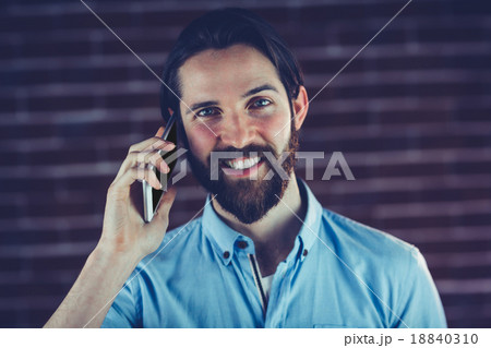 Portrait of smiling hipster using smartphone 18840310
