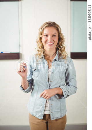 Portrait of cheerful businesswoman holding marker in creative of 18840311